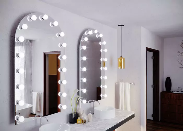 Double sink arch-shaped Hollywood mirror installed on a white wall.