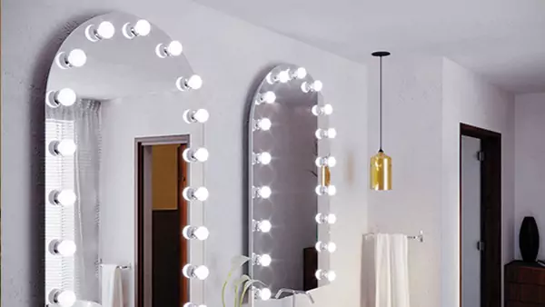 Preview of bathroom with two mirrors and many bulbs around it, providing a well-lit space for personal grooming and hygiene.