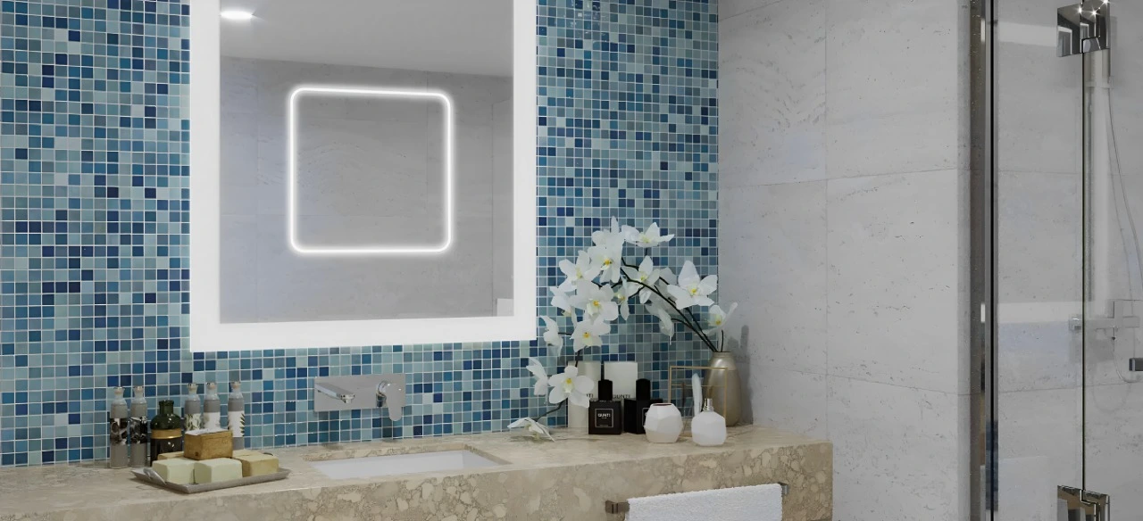 A bathroom featuring blue tiles and a large mirror, creating a serene and modern atmosphere.