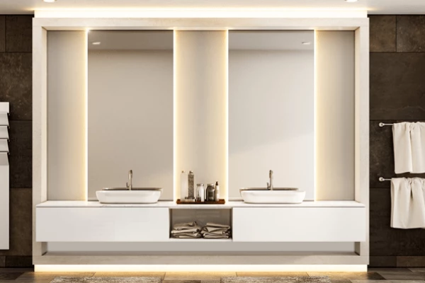 Double washbasin with two backlit mirrors inset into the wall above the white storage.