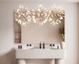 Icon of an elegant bathroom sink with a perfect-fit mirror and a pavana lamp set on a wall.