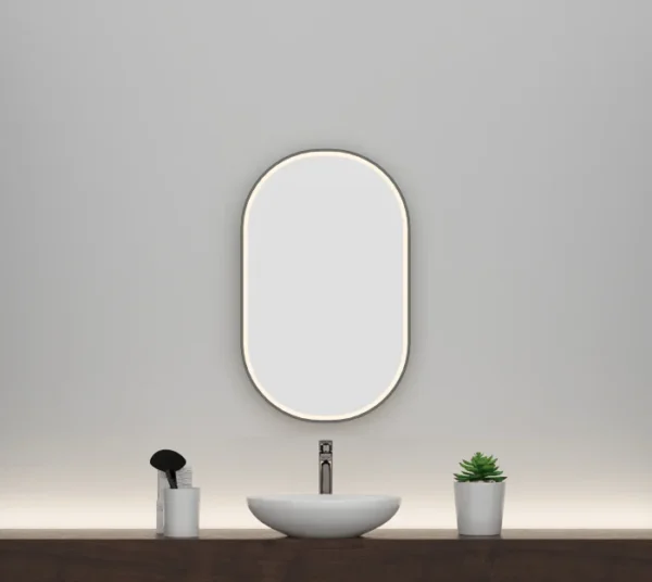 An oval-shaped warm light mirror with a 23.5x38 diameter black frame.