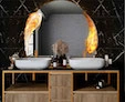 Icon of capriola bulb on a circular-shaped customized mirrors above an elegant bathroom sink.