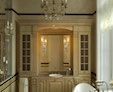 A snippet of a crystal chandelier in a luxurious washroom with a Cascia lamp in a custom mirror.