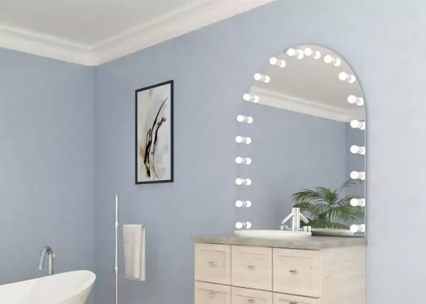 White single sink with a custom arch-shaped Hollywood mirror above a file cabinet in a bathroom.