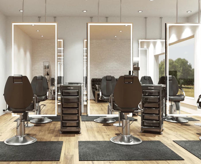 Ceiling-hung illuminated mirrors with black chairs in a beauty salon.