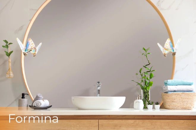 A circular-shaped lighted mirror with a stylish formina lamp gives ample light in a bathroom.