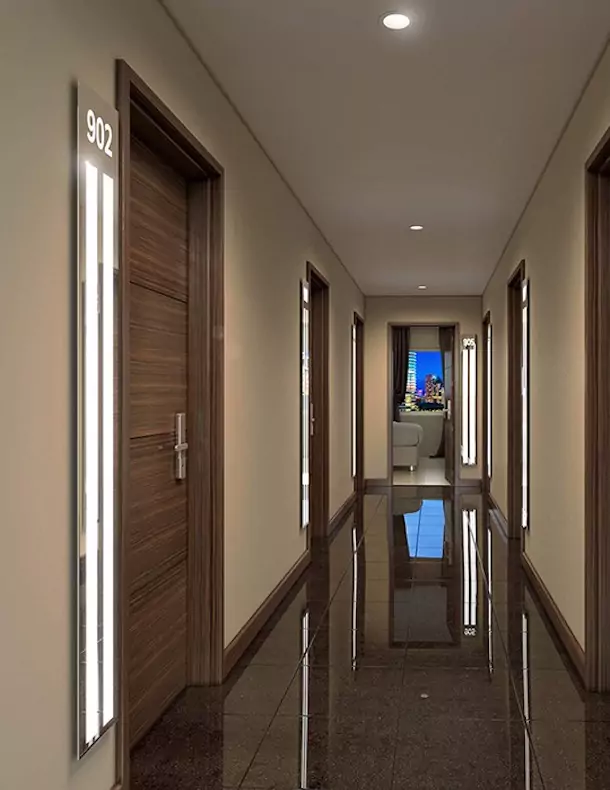 Hotel hallway with light strips near each hardwood door.