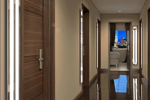 Hotel brown tiled hallway with LED light strips on the sides of each wooden door.