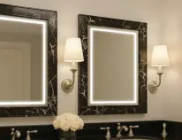 Snippet of a custom-frosted mirror with aesthetic tiles seamlessly blends into a classy bathroom.