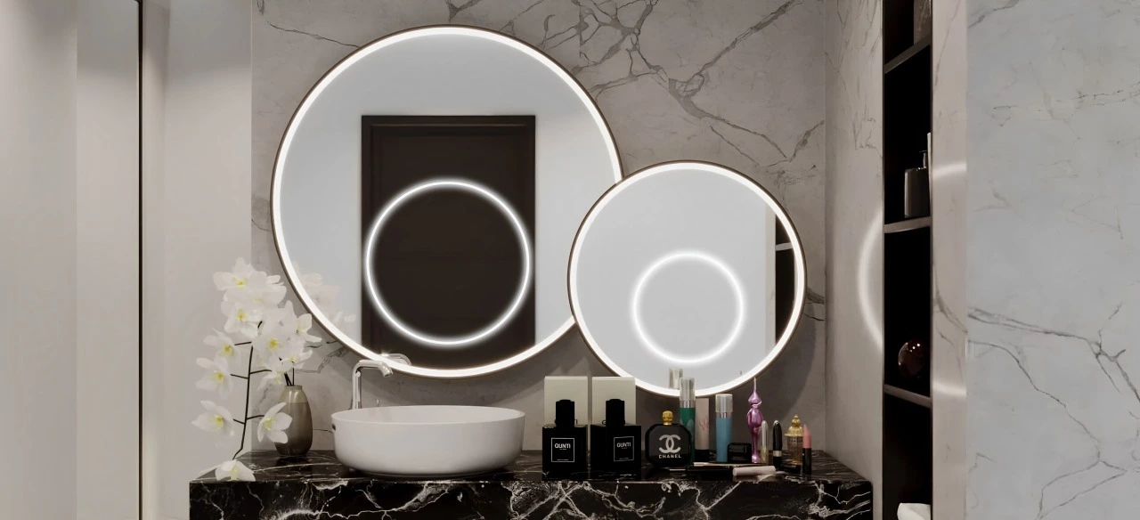 A well-lit bathroom with two stylish mirrors and a sleek sink, emphasizing a contemporary aesthetic.