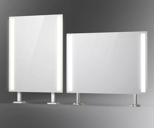 Rectangular shaped stainless steel countertop-mounted mirrors with lights strips.